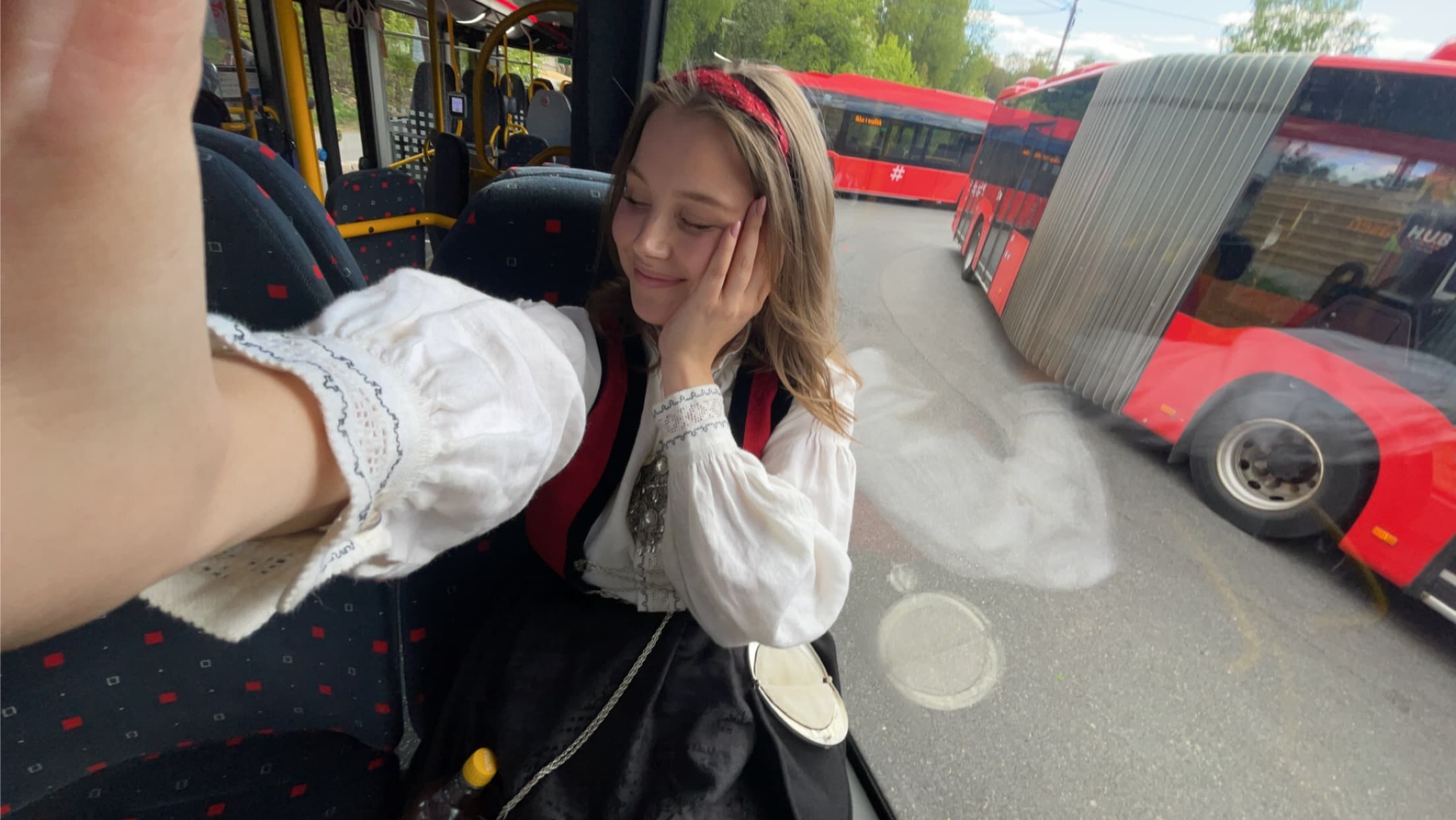 Candid photo on a bus, wearing traditional Norwegian bunad